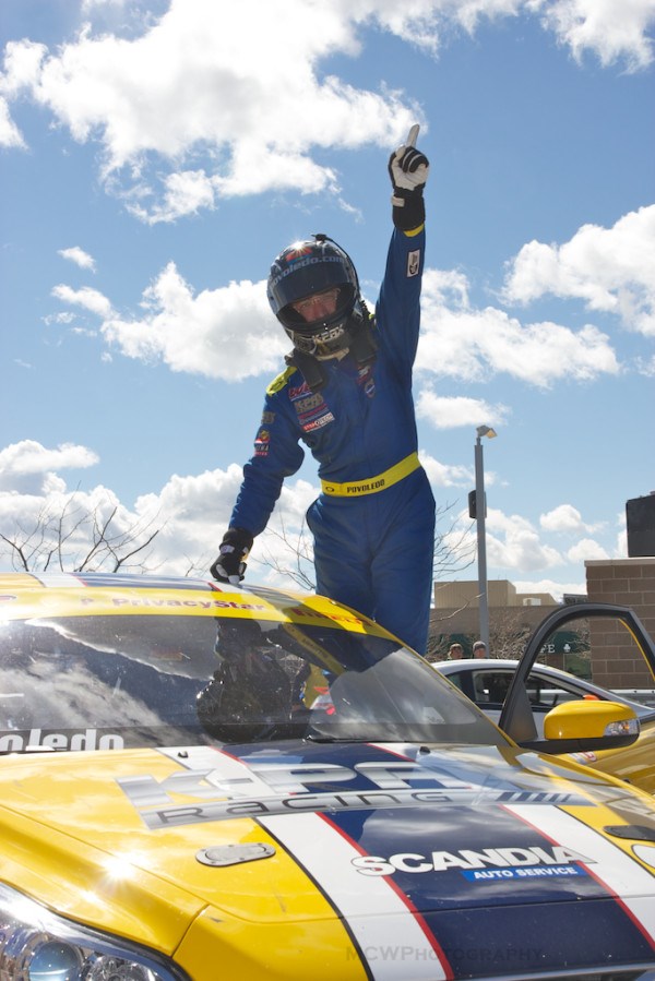 Aaron Povoledo celebrates in victory lane at Miller Motorsports Park in Utah.